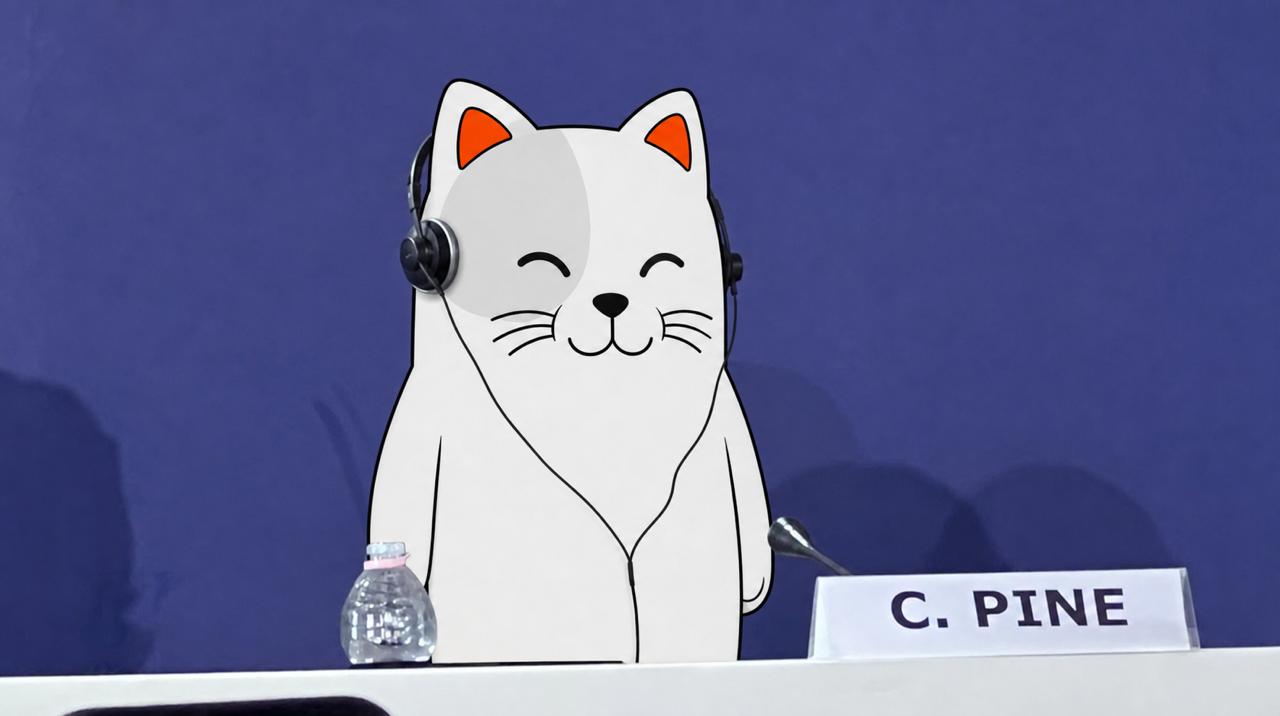 Purr Cat wearing headphones at a conference panel